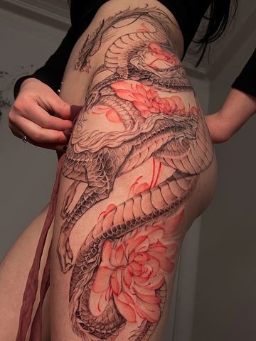 Dragon tattoo with peonies on hips in Asian style with black and red ink delicate  hand drawn design