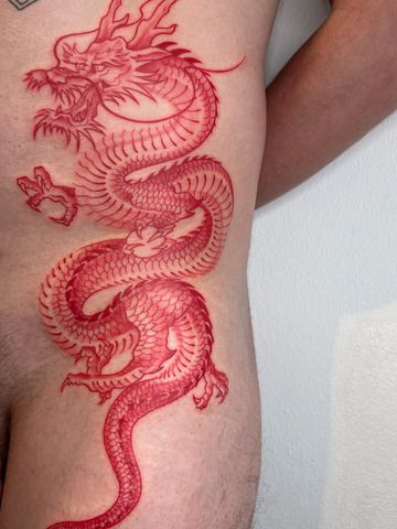 Dragon fine line tattoo hips black an red ink hand drawn design delicate  Asian style tattooed man 
