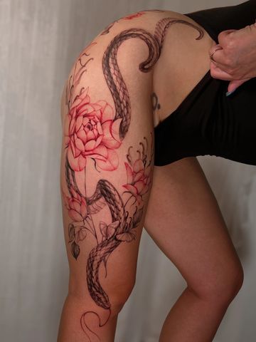 Snake tattoo on thigh  line black an red ink hand drawn design floral feminine flowers