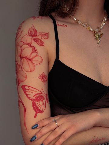 Magnolia tattoo red ink Asian style fine line hand drawn design tattoo on arm floral petite delicate