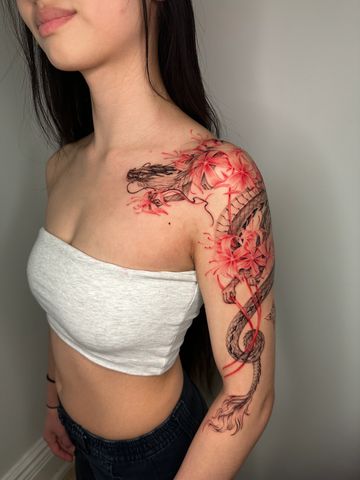 Dragon tattoo red ink Asian style fine line hand drawn design on shoulder floral petite lilies
