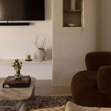 Cozy living room corner with a brown armchair and minimalist decor.