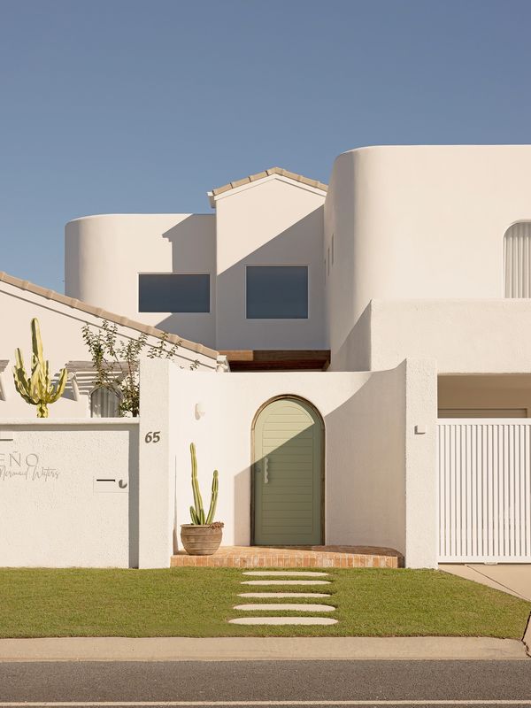 Modern white house with clean architecture and green door.