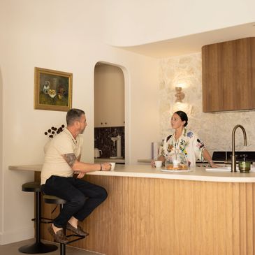 Man and woman talking in a modern kitchen.