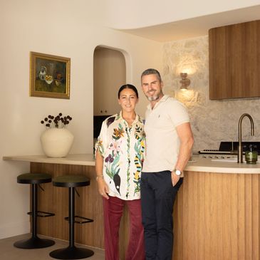 Couple standing together in a modern kitchen.