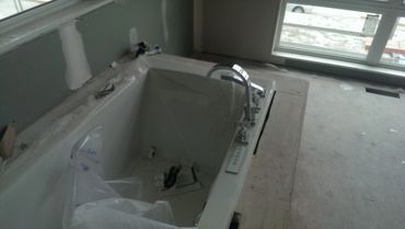 New Bath tub installation during renovation. Rough plumbing completed.