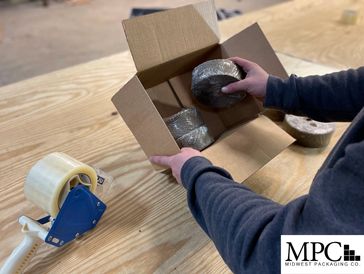 Midwest Packaging at work packing boxes with product. MPC is based out of the Cleveland area. 
