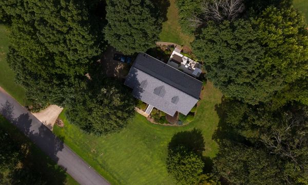 Drone roof view of residential property with drone
