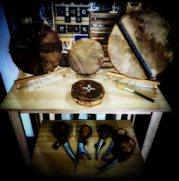 Various sized drums and rattles with antler handles.