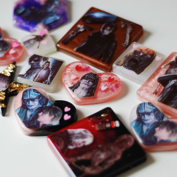 Handmade resin pieces featuring dark, gothic character designs and heart motifs.