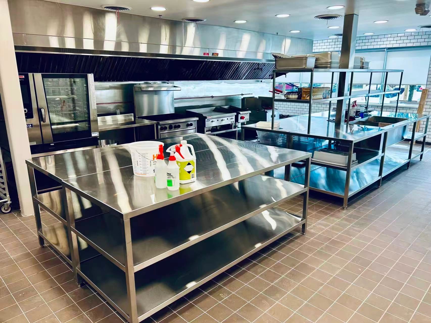 Clean and organized commercial kitchen with stainless steel surfaces.