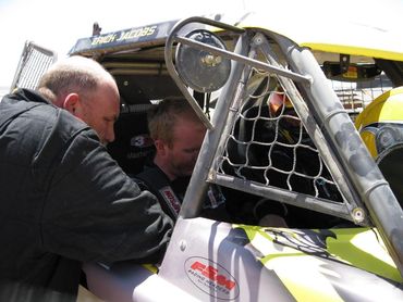 Class one buggy leaving pits after driver and navigator change during off road desert race. 