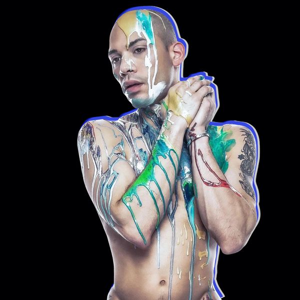 This is an image of Emmanuel Claudio, the creative director of the school covered in paint.
