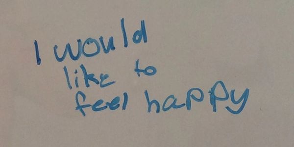 Child begins the Brain Gym® goal-setting process by writing her thoughts on a white board. 