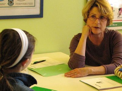 Deborah  Scott Studebaker works with a young poet.