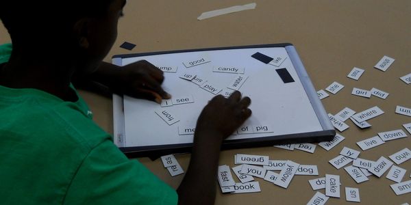 A boy works with magnetic poetry tiles in one of Deb Studebaker's classes.