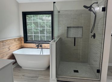 Modern bathroom with freestanding tub and glass shower.