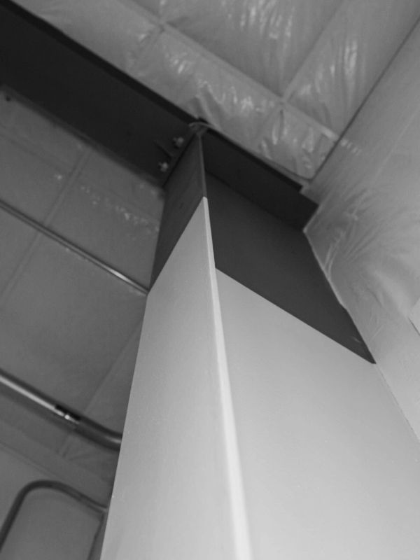 Black and white photo of a steel column from below.