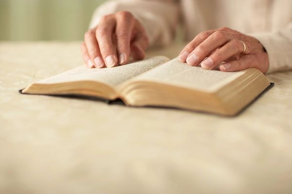 A person reading a book on a table