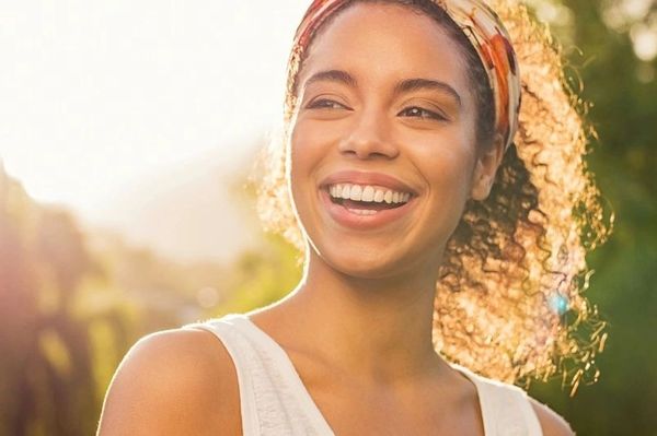 Young Woman From Africa Grinning at Sunset