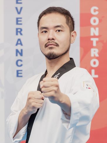 Martial artist in a white uniform with a focused punch pose.