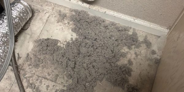 Clogged dryer vent lint removal for residential home fire safety in Maricopa, AZ.