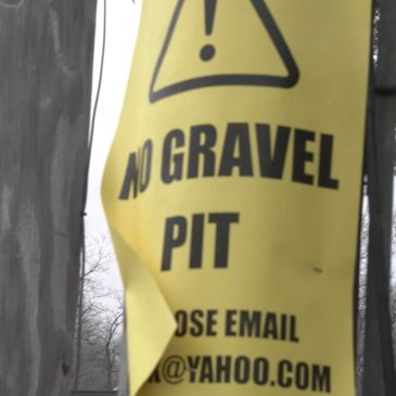 A sign stating No Gravel Pit urging residents to contact the township planning chairperson