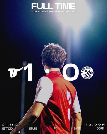 Football match ends 1-0 with a player in red jersey illuminated by stadium lights.