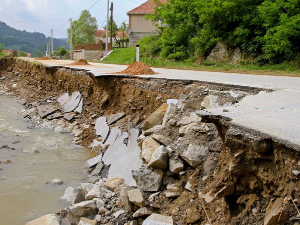 Broken side of a street from flooding
