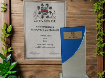 Certificate and trophy for a dog training exam passed by Yvonne Zwick and Boss.
