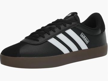 Black Adidas sneaker with white stripes and brown sole.
