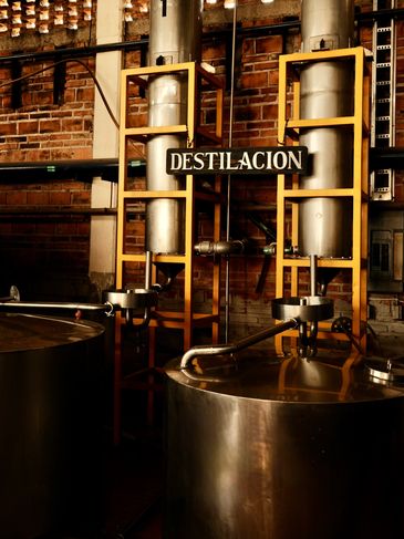 Industrial distillation equipment in a factory setting.