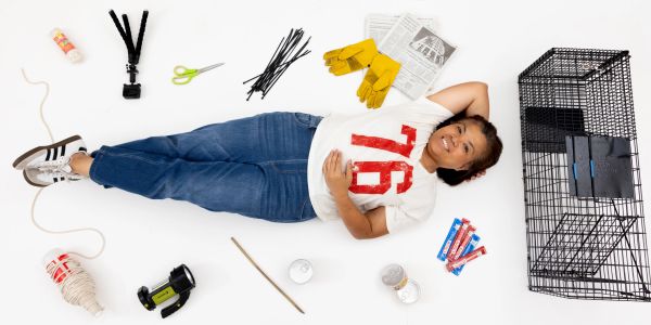 Woman lying surrounded by DIY and gardening supplies.