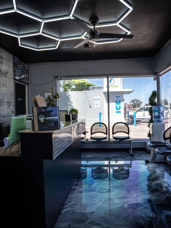 Modern waiting area with geometric ceiling lights and polished floor.