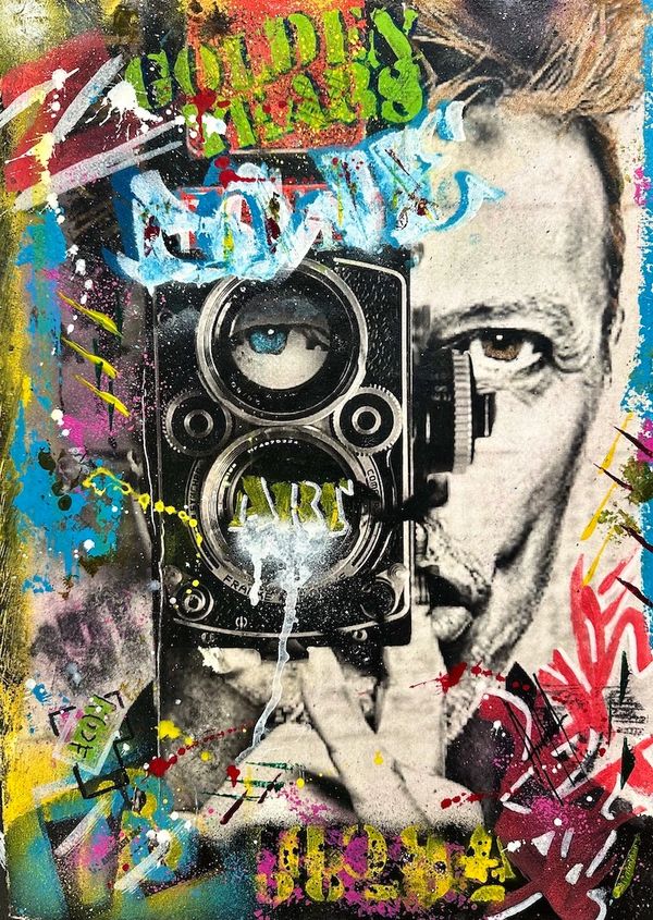 Street art of a man holding a vintage camera with vibrant graffiti accents.