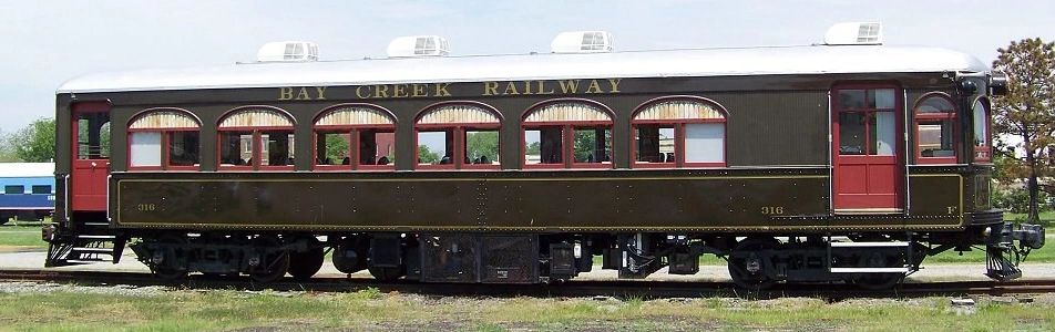 Vintage Bay Creek Railway passenger railcar with classic design and dark brown exterior.