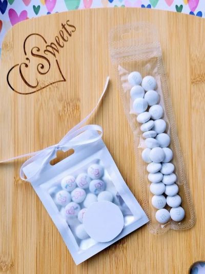 White mints in two different packaging on a wooden board.