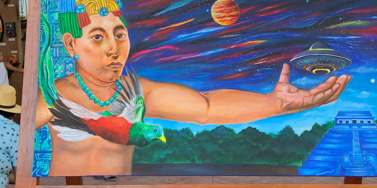 Colorful mural depicting a man with a bird, cosmic elements, and ancient architecture.