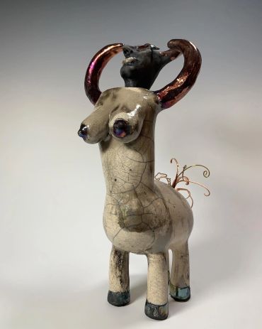 Sculpture of a fantastical creature with a humanoid torso and animal legs.