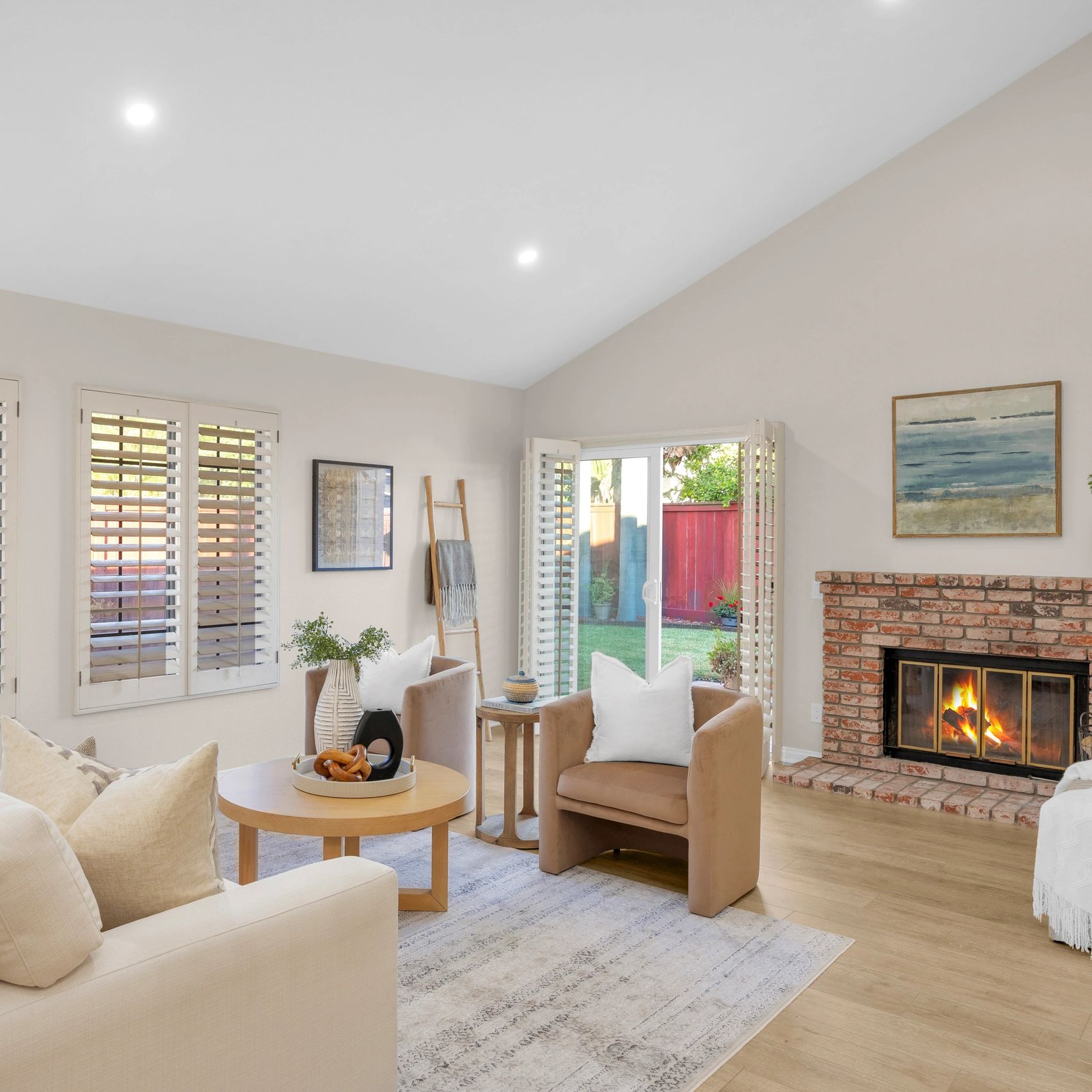 Cozy living room with fireplace and natural light.