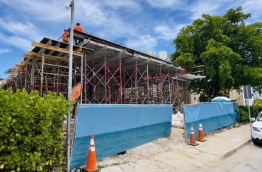 Construction site with scaffolding and workers.
