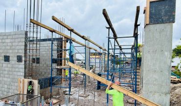 Construction site with scaffolding and workers.