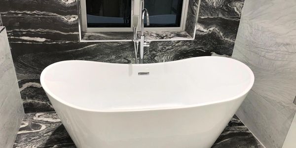 Tub bath in modern chrome bathroom