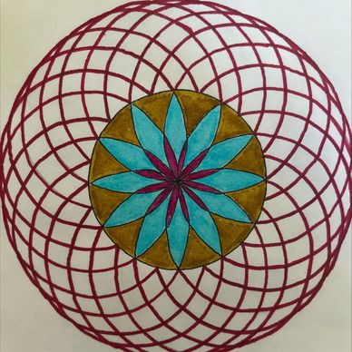 Colorful geometric mandala with blue, brown, and red patterns.