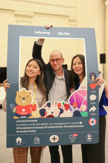 Faye Ying and two others posing with a YouCount Canada social media frame promoting youth civic engagement.