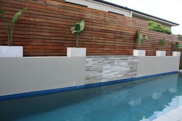 Timber Merbau Screen Feature stack stone wall and paving to pool area in Beaconsfield