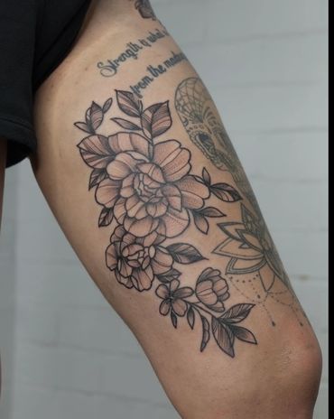 Flower on inner thigh tattoo