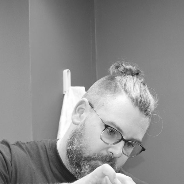 Chay, the barber, cutting hair using scissors and comb