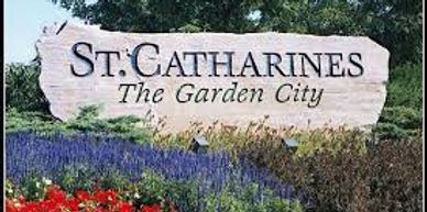 Welcome sign for St. Catharines, The Garden City, surrounded by flowers.