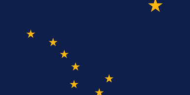 The flag of Alaska with eight gold stars on a dark blue background.